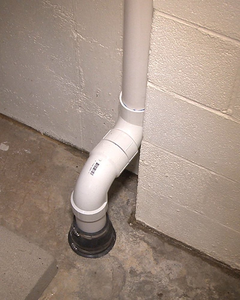 Interior radon suction point piped through a Eau Claire County basement slab